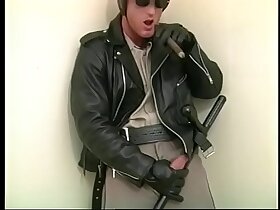 Muscular homo stud in police uniform rubs his cock till it spits cum on his hand