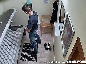 Young man secretly filmed in public solarium